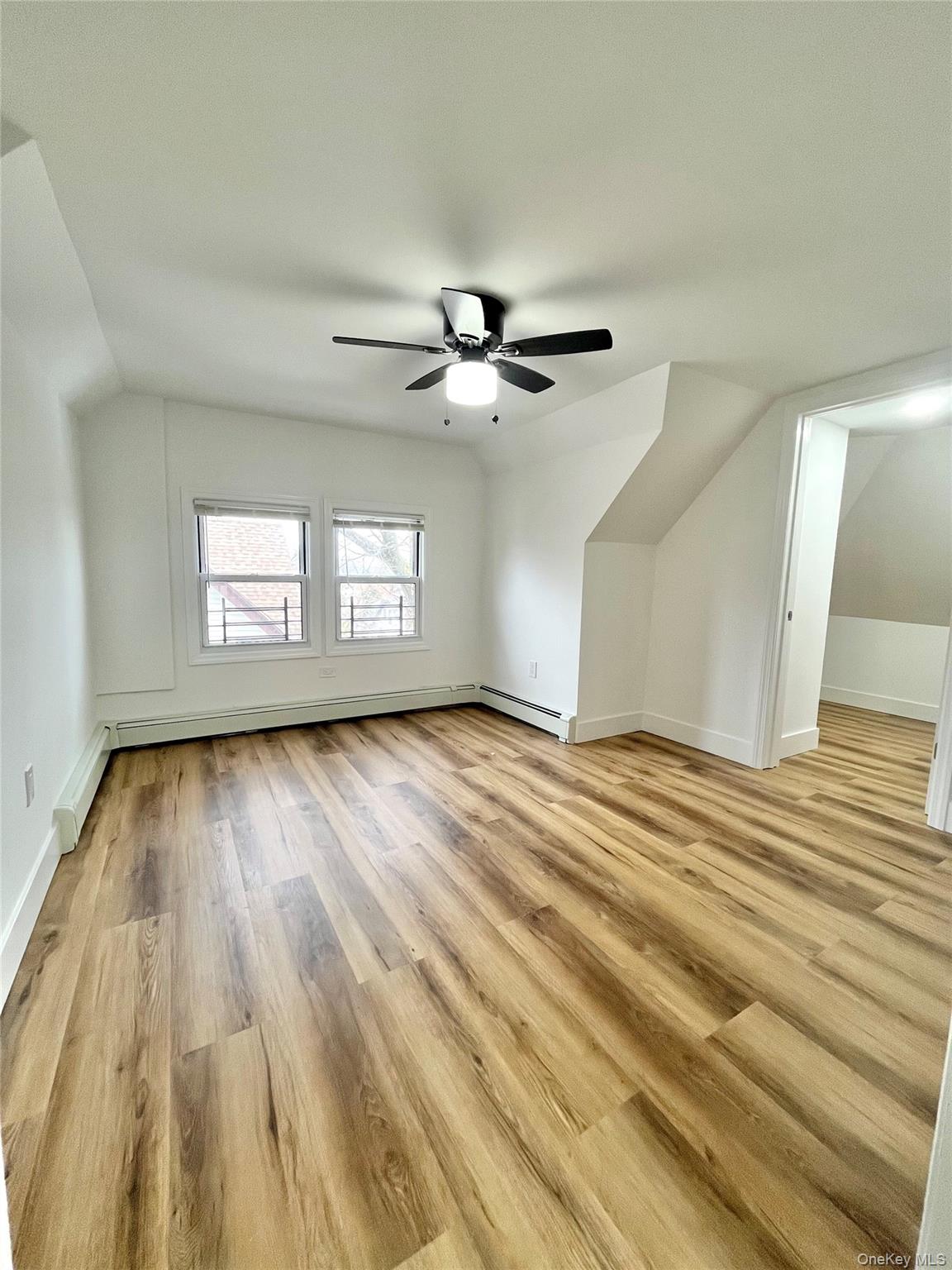 123 Clinton Avenue, Unit 2 New Rochelle, NY 10801 - Photo 17 of 27 a view of empty room with wooden floor and fan