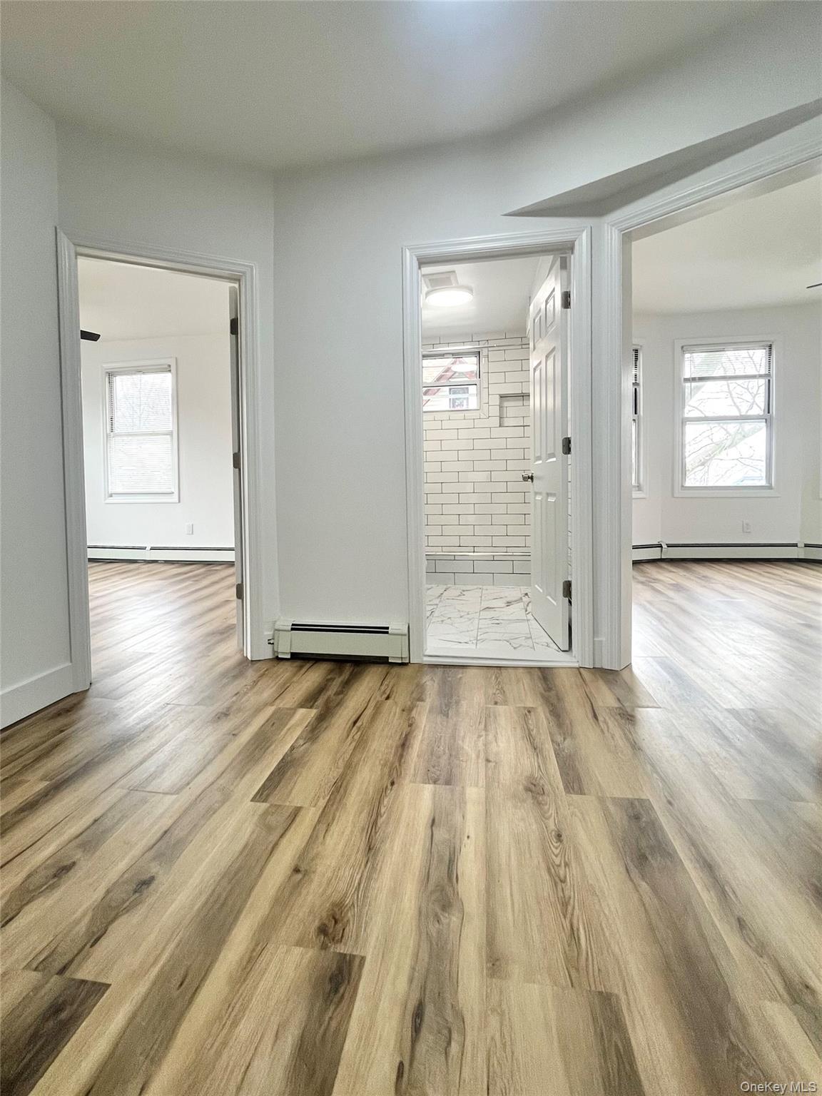 123 Clinton Avenue, Unit 2 New Rochelle, NY 10801 - Photo 2 of 27 a view of an empty room and wooden floor