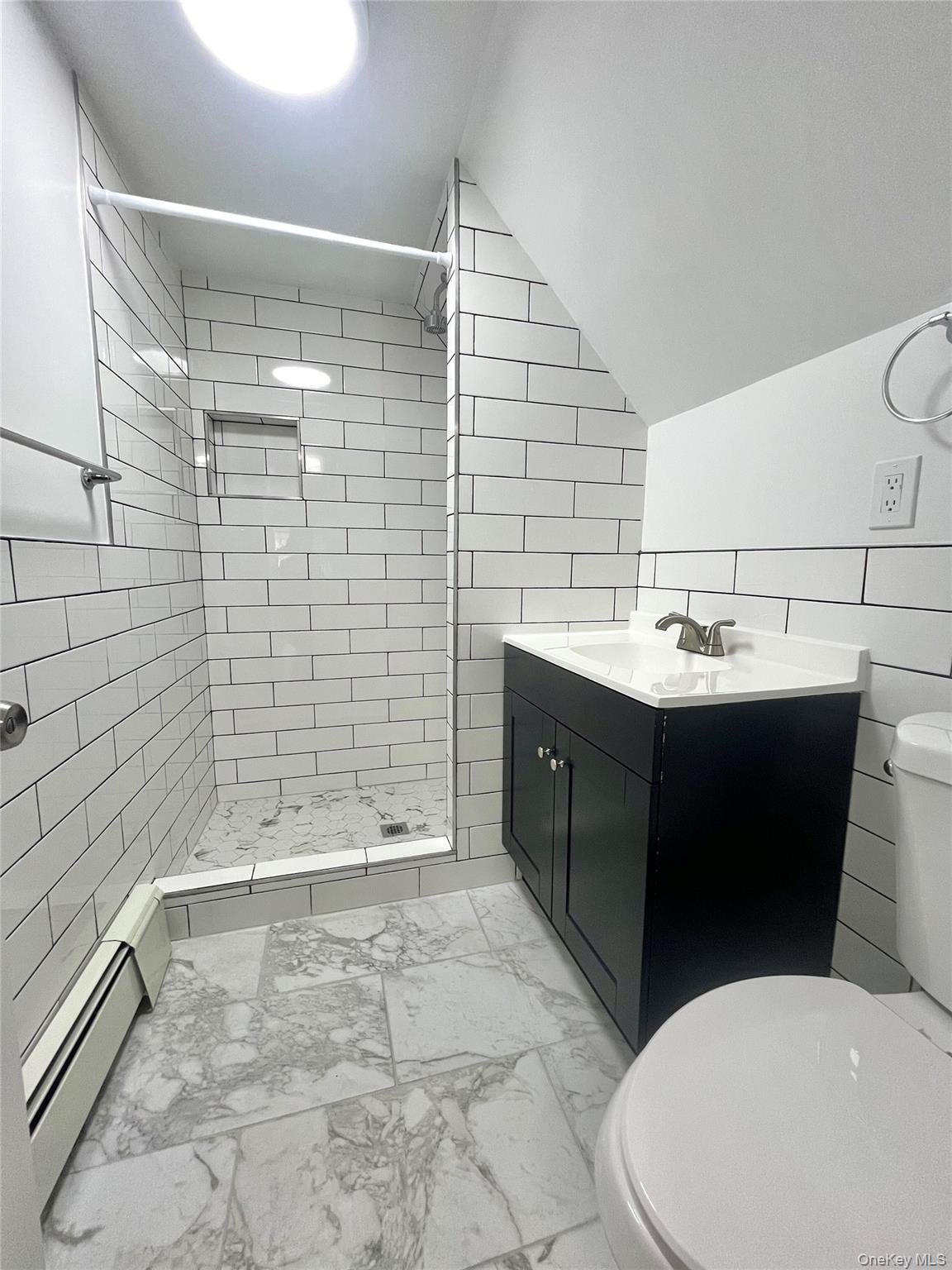 123 Clinton Avenue, Unit 2 New Rochelle, NY 10801 - Photo 23 of 27 a bathroom with a sink a toilet and shower