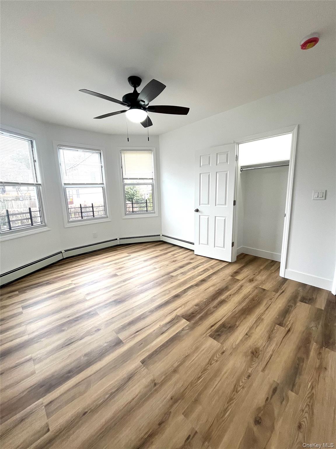 123 Clinton Avenue, Unit 2 New Rochelle, NY 10801 - Photo 10 of 27 wooden floor in an empty room with a window