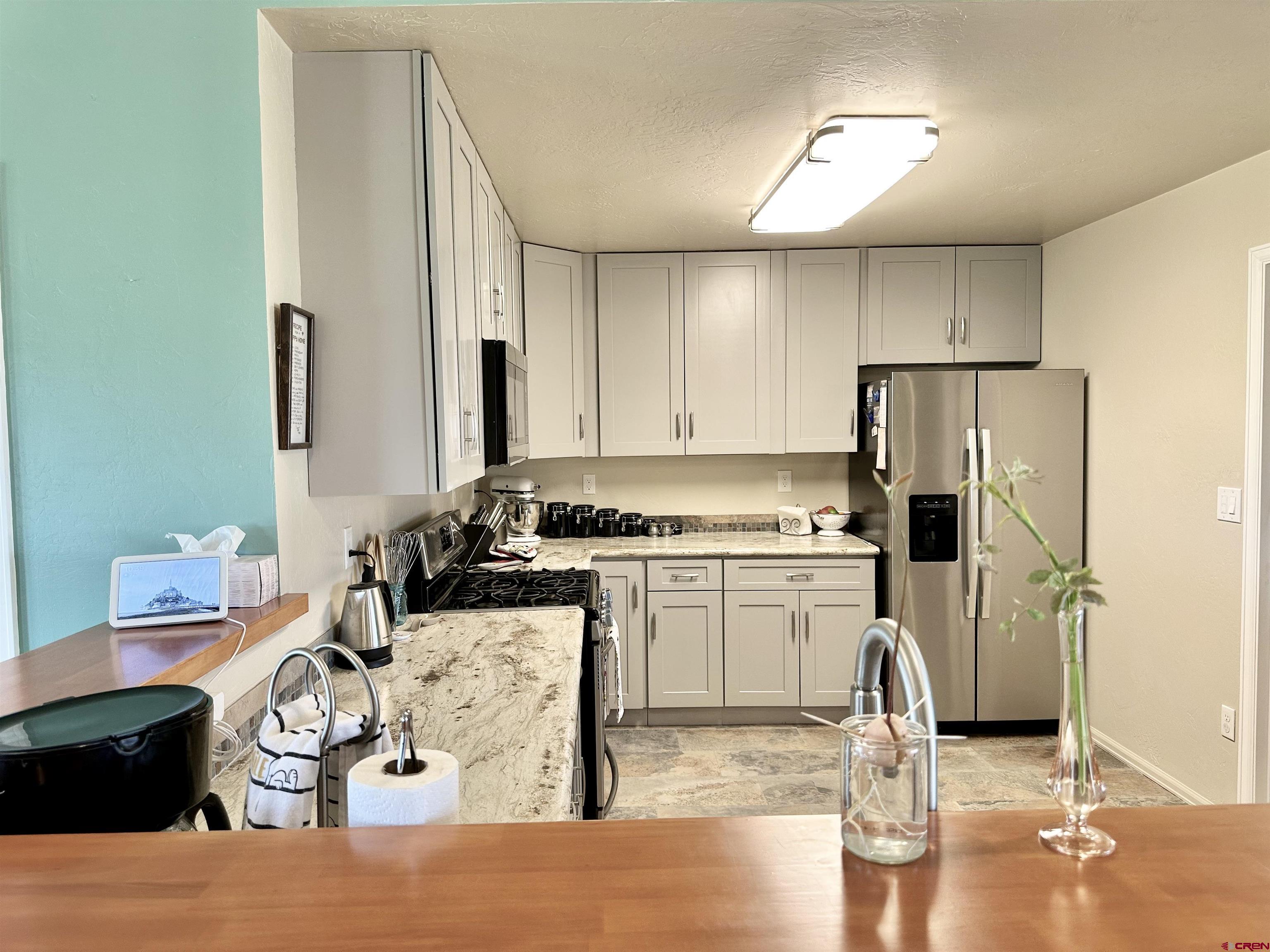 8352 2000th Road Austin, CO 81410 - Photo 13 of 35 a kitchen with a refrigerator sink and cabinets