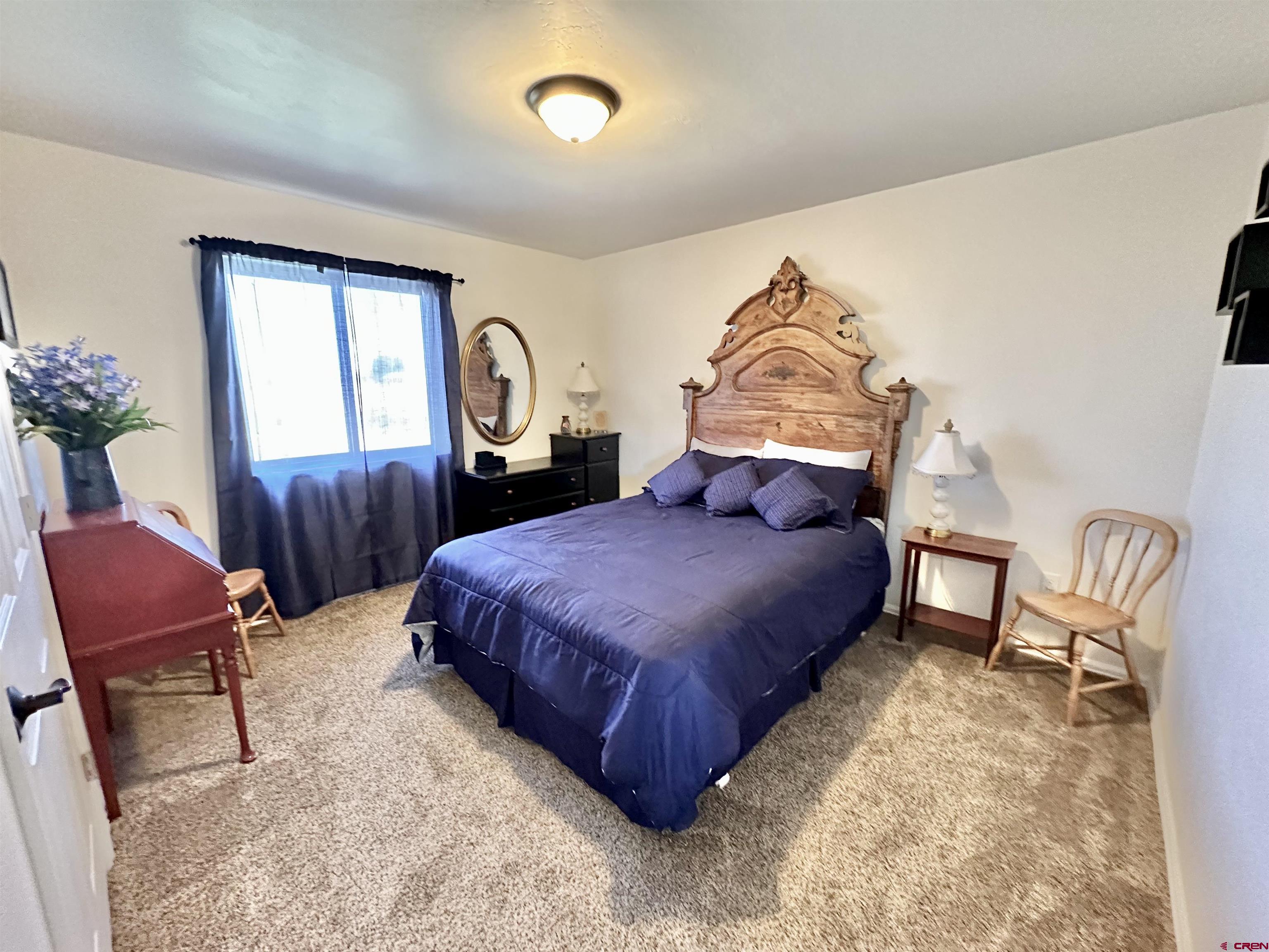 8352 2000th Road Austin, CO 81410 - Photo 22 of 35 a bedroom with a bed chair and window