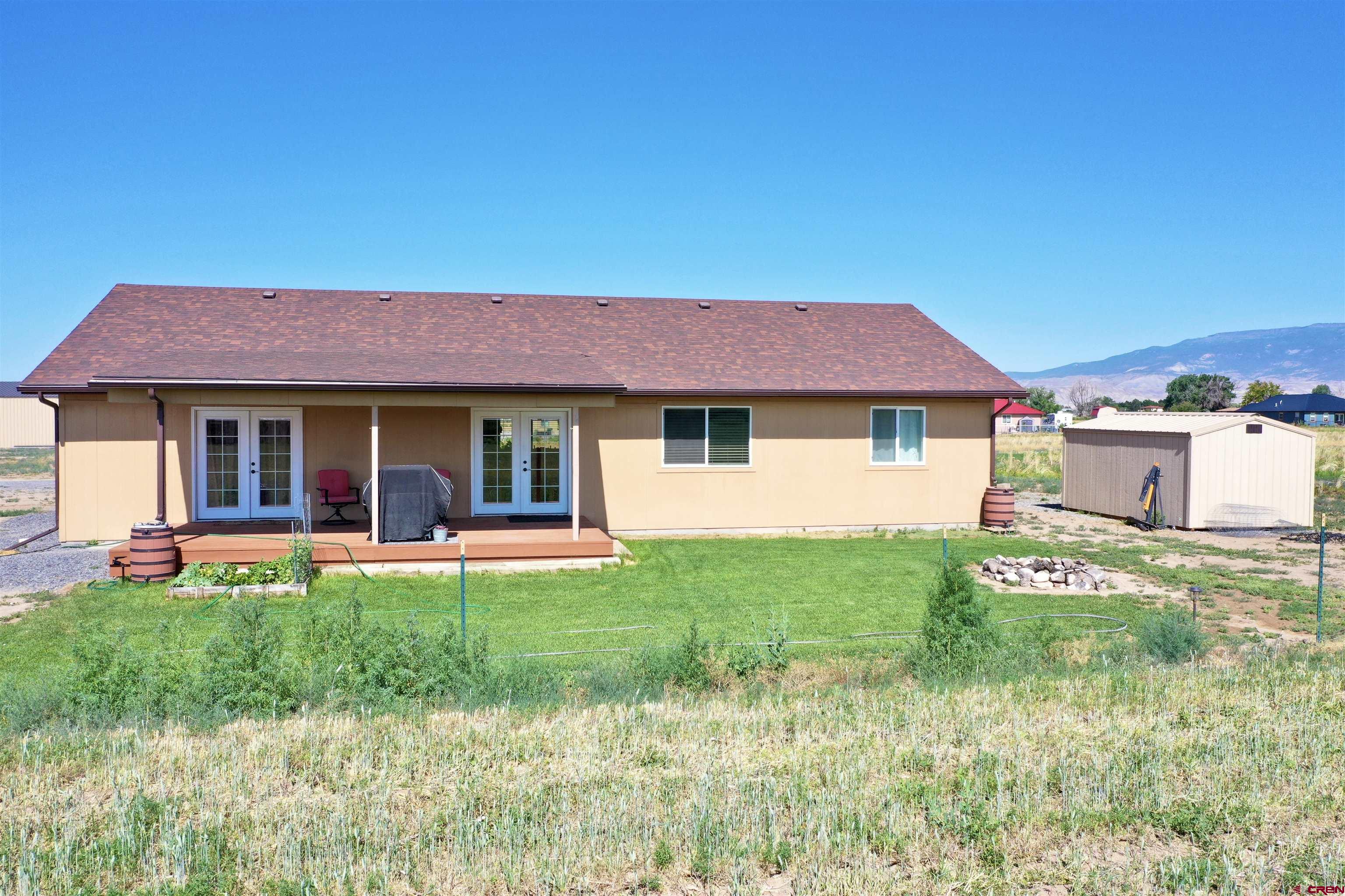 8352 2000th Road Austin, CO 81410 - Photo 29 of 35 a front view of a house with a yard and trees