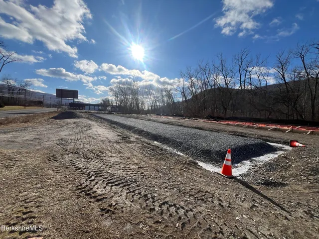 a view of a yard with wooden fence