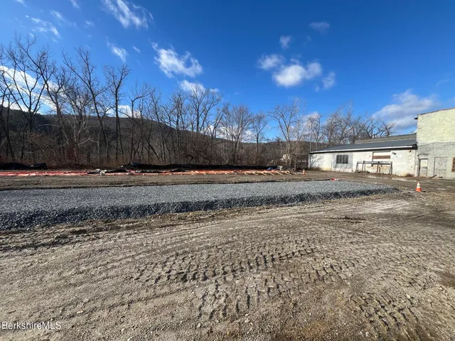 a view of a yard with wooden fence