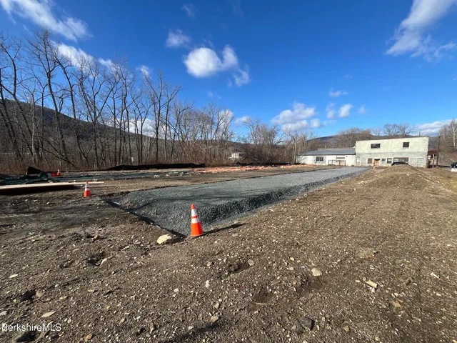 a view of a yard with wooden fence