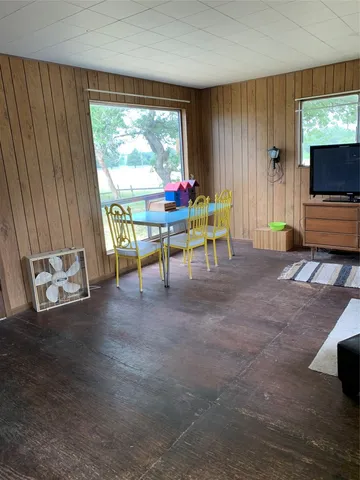 a view of a livingroom with furniture and a window