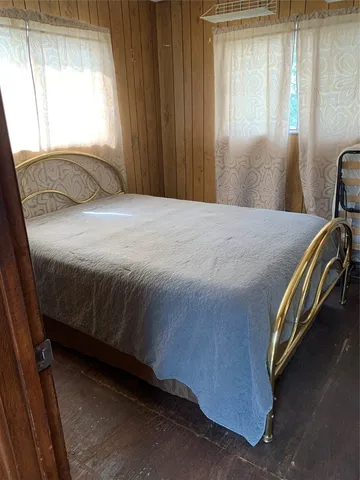 a bedroom with a bed and window