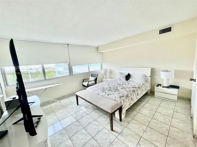 a bedroom with a bed and flat screen tv