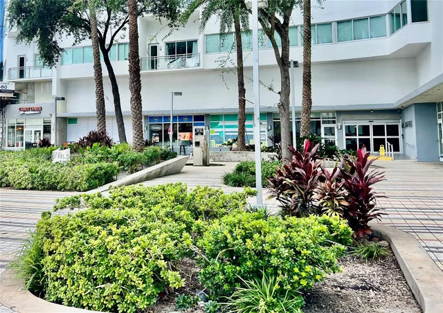 a view of a house with a flower garden