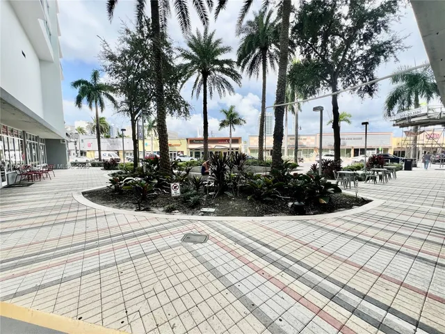 a view of multiple houses with palm trees