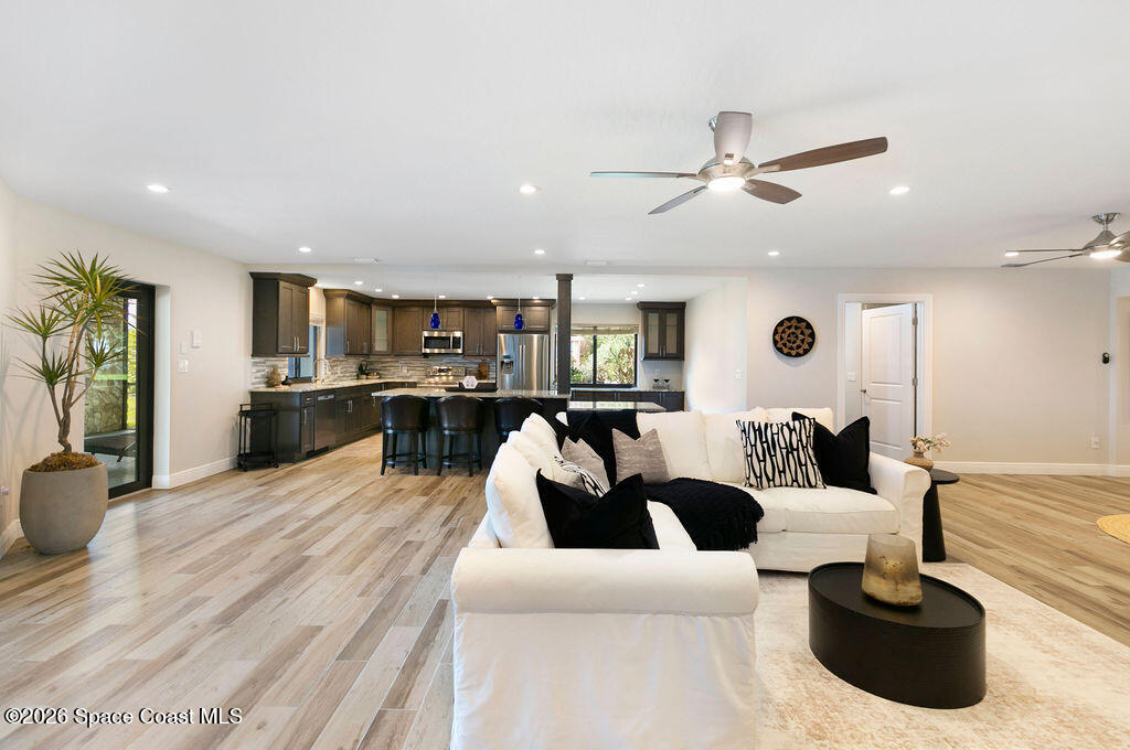 110 Barnacle Place Rockledge, FL 32955 - Photo 38 of 71 a living room with furniture a wooden floor and chandelier