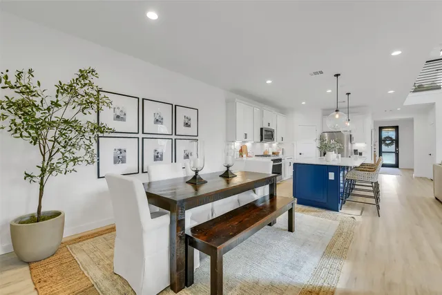 a kitchen with a sink a stove cabinets and wooden floor