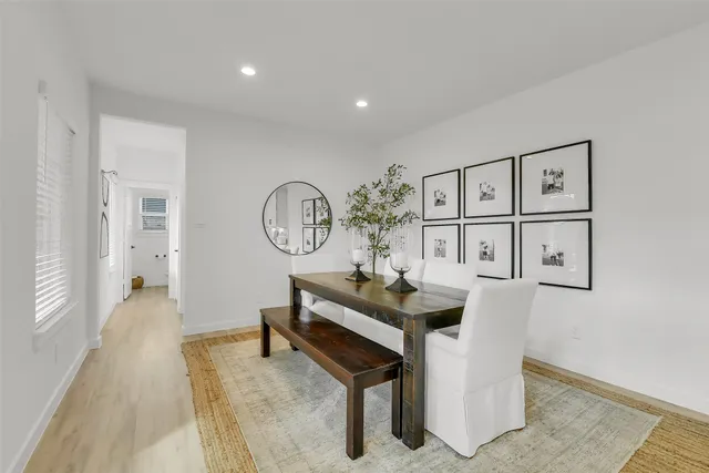 a living room with furniture and paintings on the wall