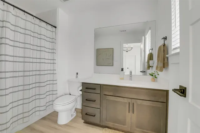 a spacious bedroom with a bed and ceiling fan