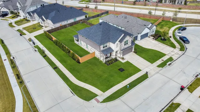 an aerial view of a tennis ground and a swimming pool