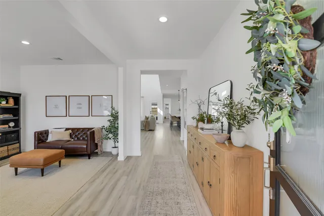 a living room with furniture and a potted plant