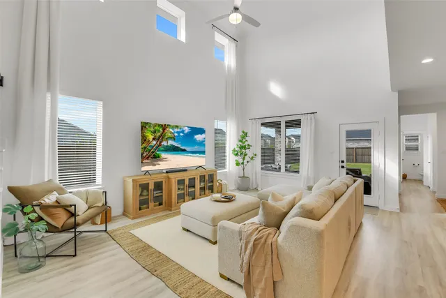 a living room with furniture flat screen tv and white walls