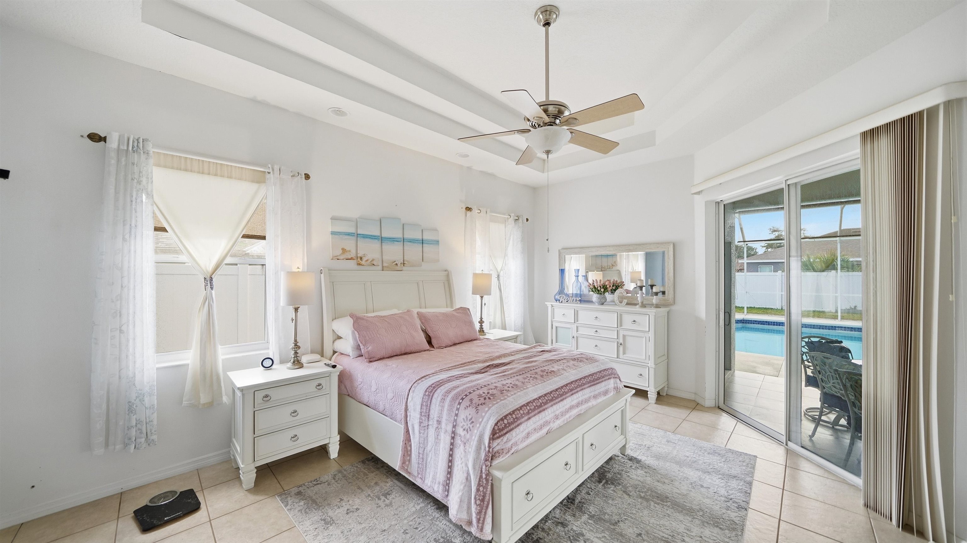 22 Flanders Lane Palm Coast, FL 32137 - Photo 13 of 70 a bedroom with a large bed and a chandelier