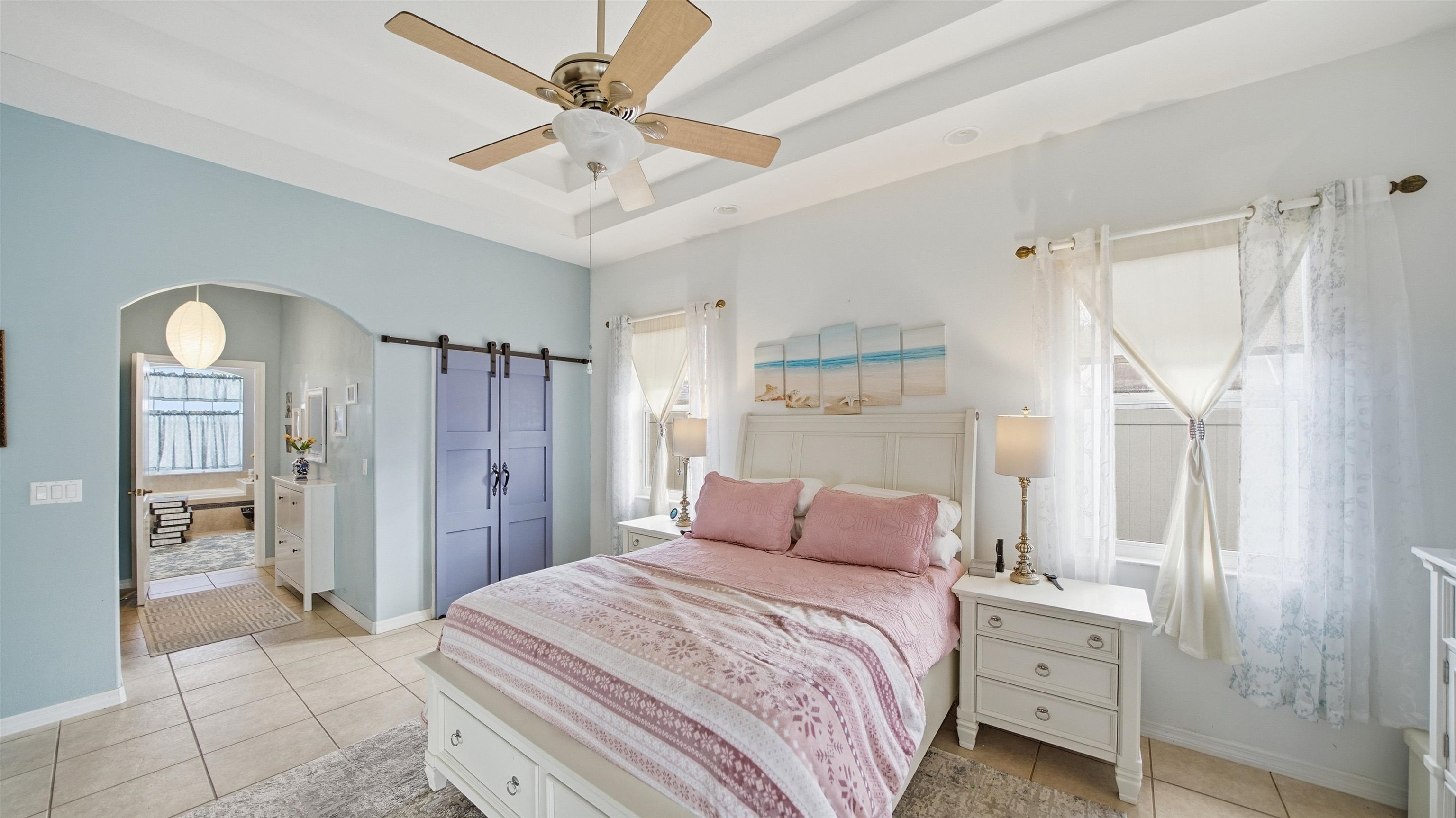 22 Flanders Lane Palm Coast, FL 32137 - Photo 14 of 70 a bedroom with a bed and a chandelier
