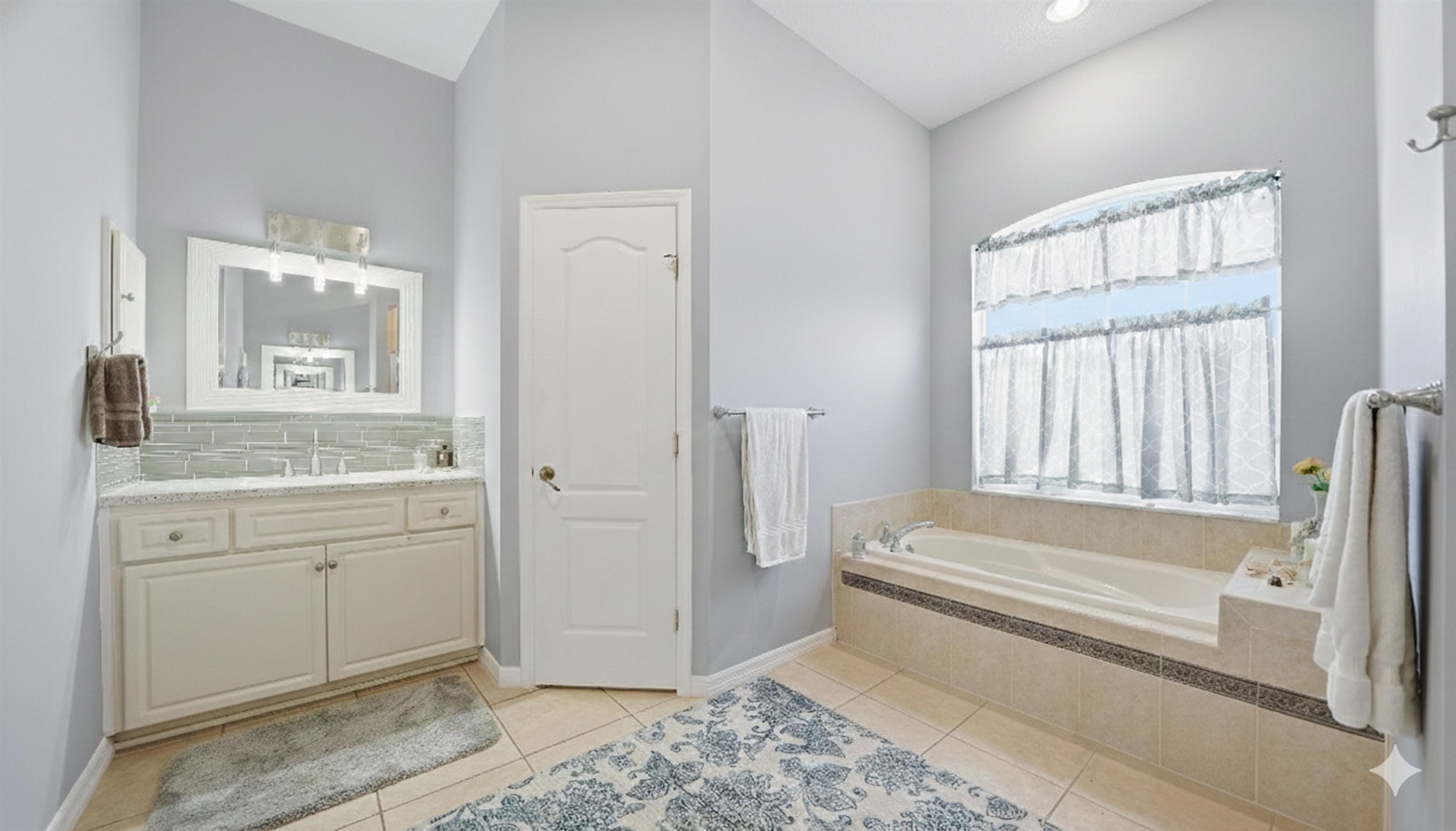 22 Flanders Lane Palm Coast, FL 32137 - Photo 18 of 70 a bathroom with a granite countertop sink and a bathtub