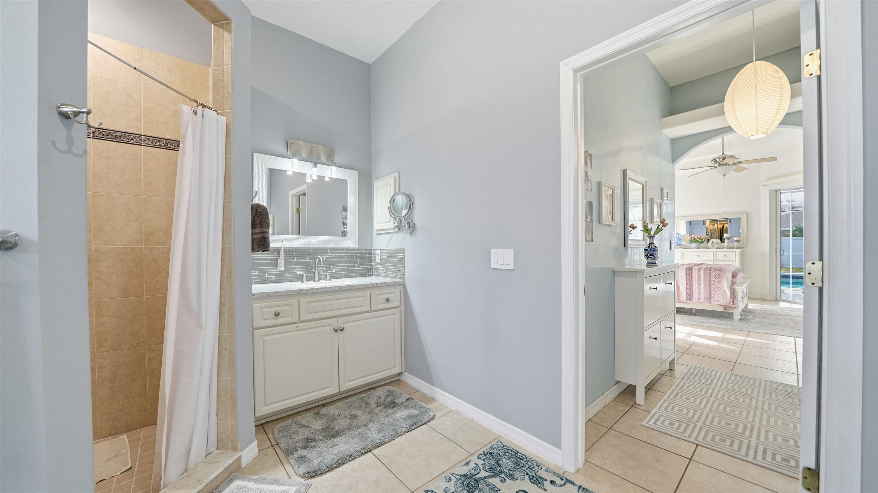 22 Flanders Lane Palm Coast, FL 32137 - Photo 20 of 70 a bathroom with a granite countertop sink mirror and a shower