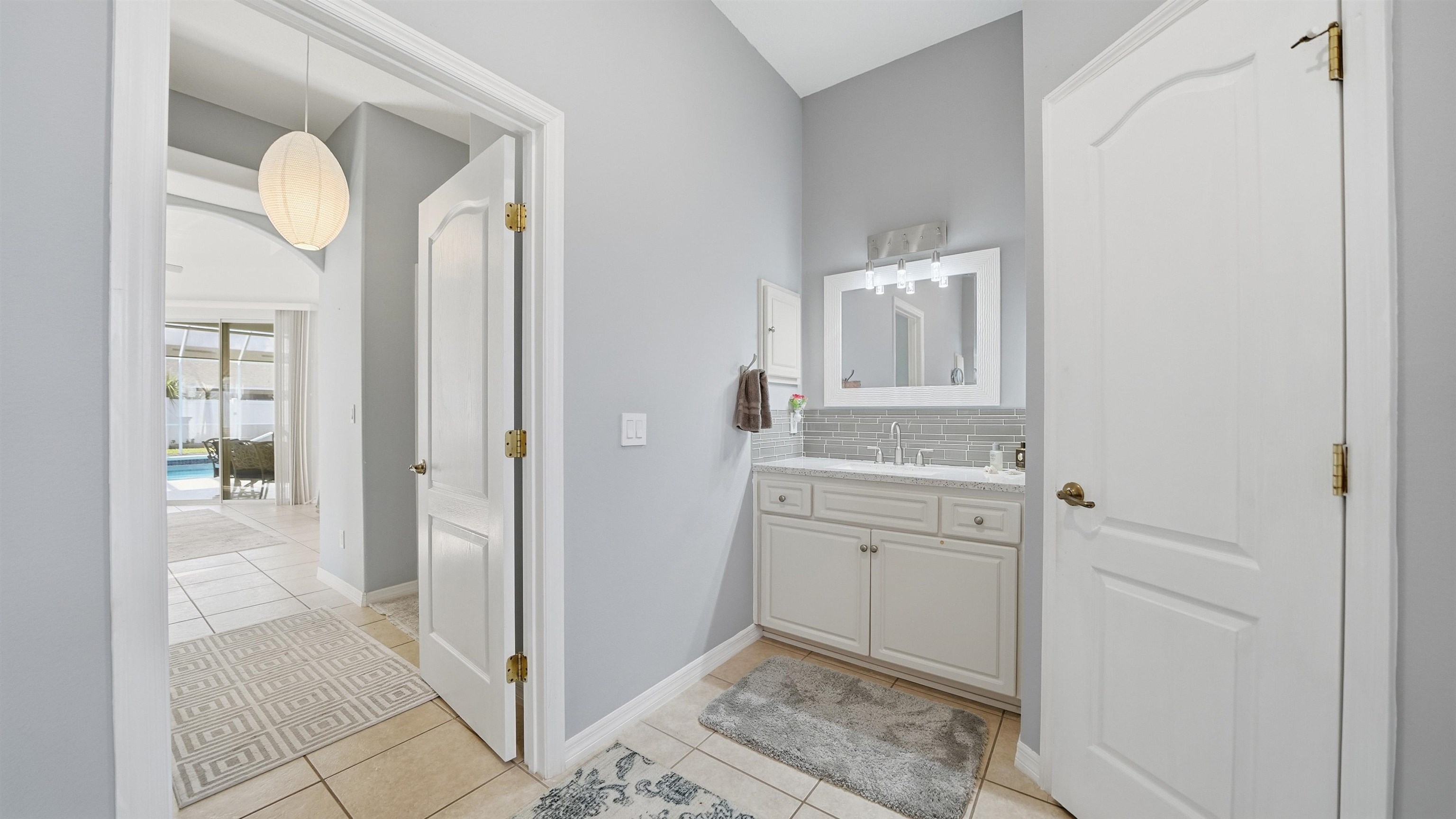 22 Flanders Lane Palm Coast, FL 32137 - Photo 21 of 70 a bathroom with a granite countertop sink and a mirror