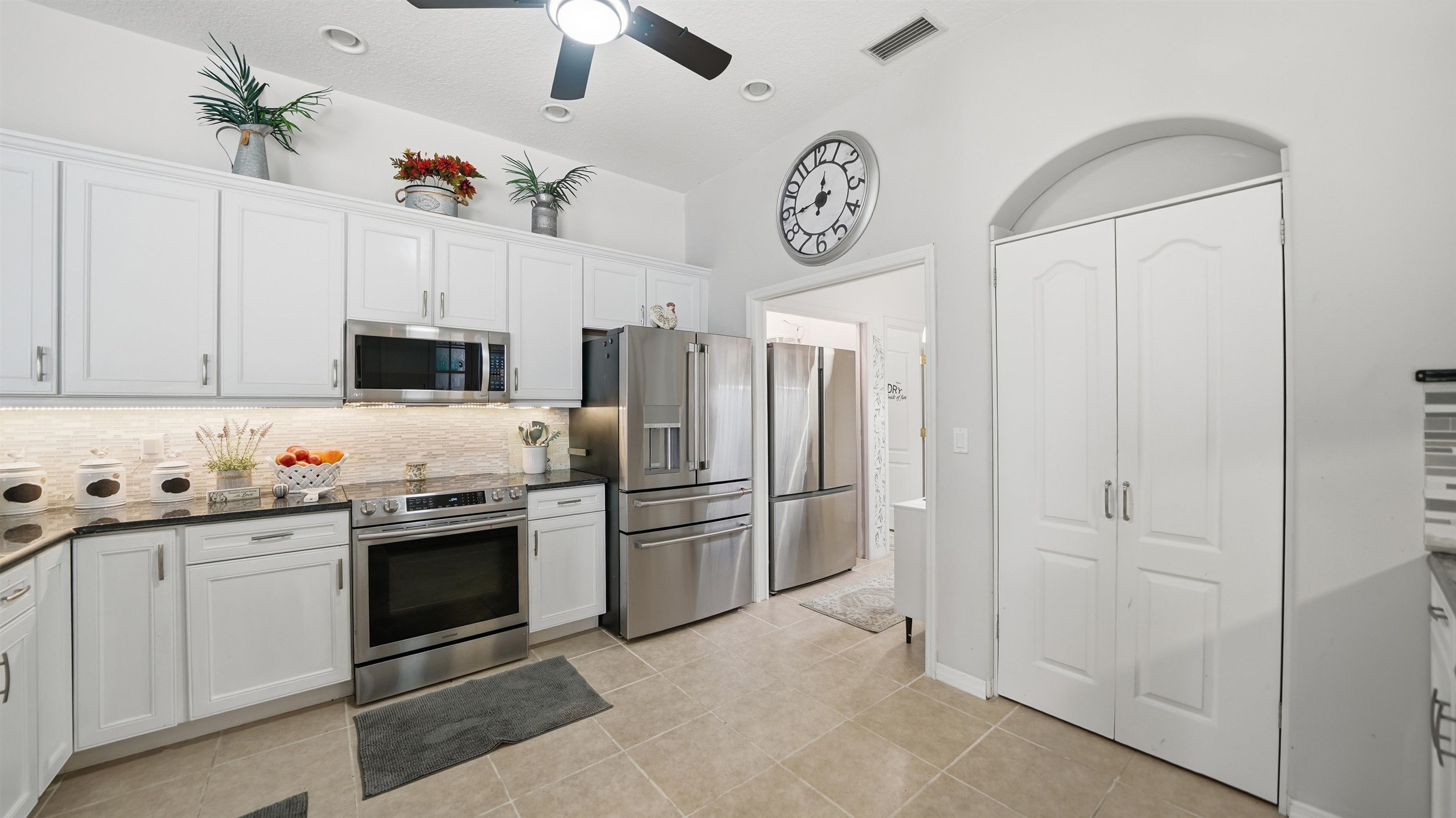 22 Flanders Lane Palm Coast, FL 32137 - Photo 29 of 70 a kitchen with cabinets and stainless steel appliances