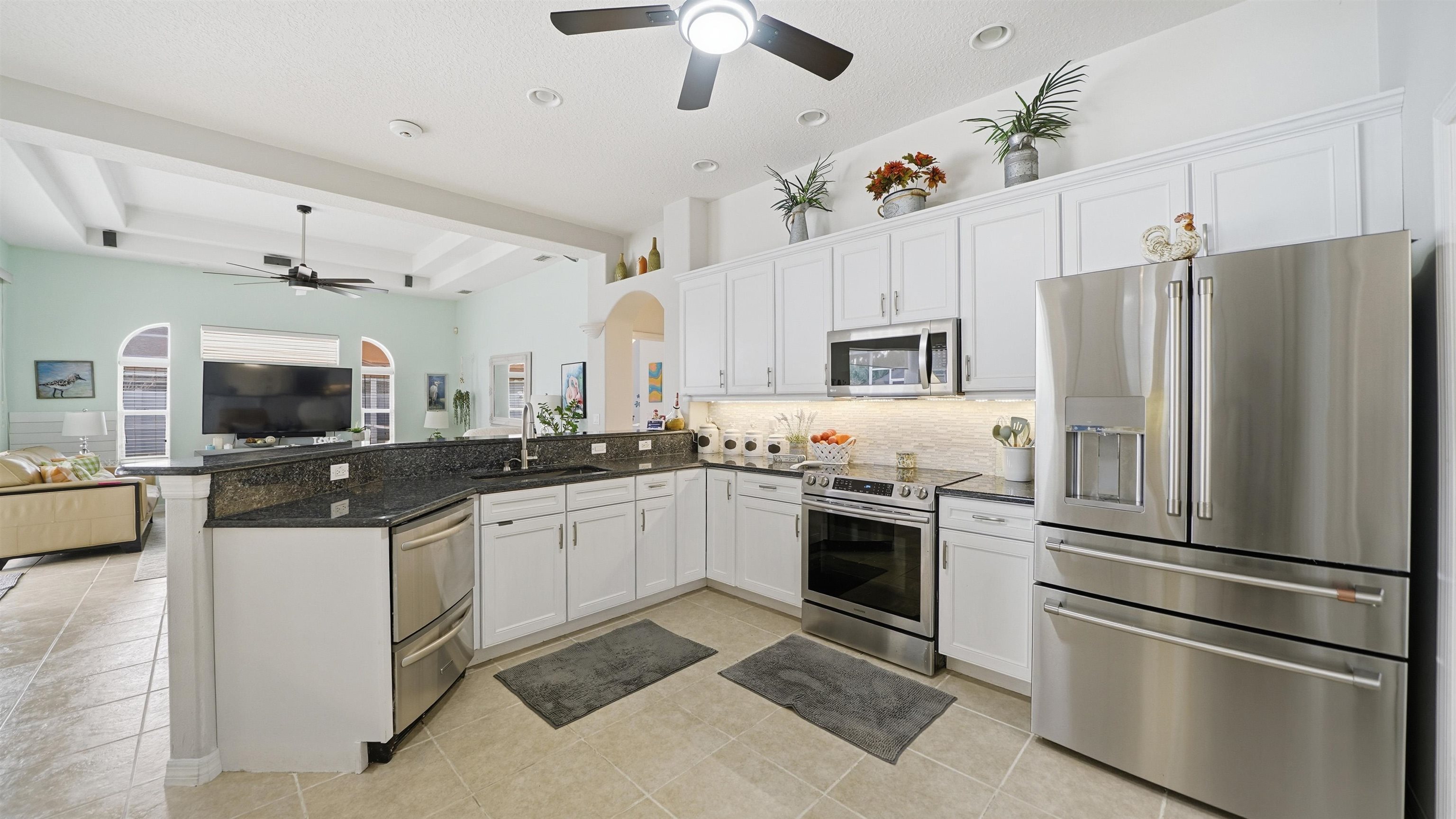 22 Flanders Lane Palm Coast, FL 32137 - Photo 69 of 70 Kitchen with a ceiling fan, appliances with stainless steel finishes, white cabinetry, open floor plan, and recessed lighting