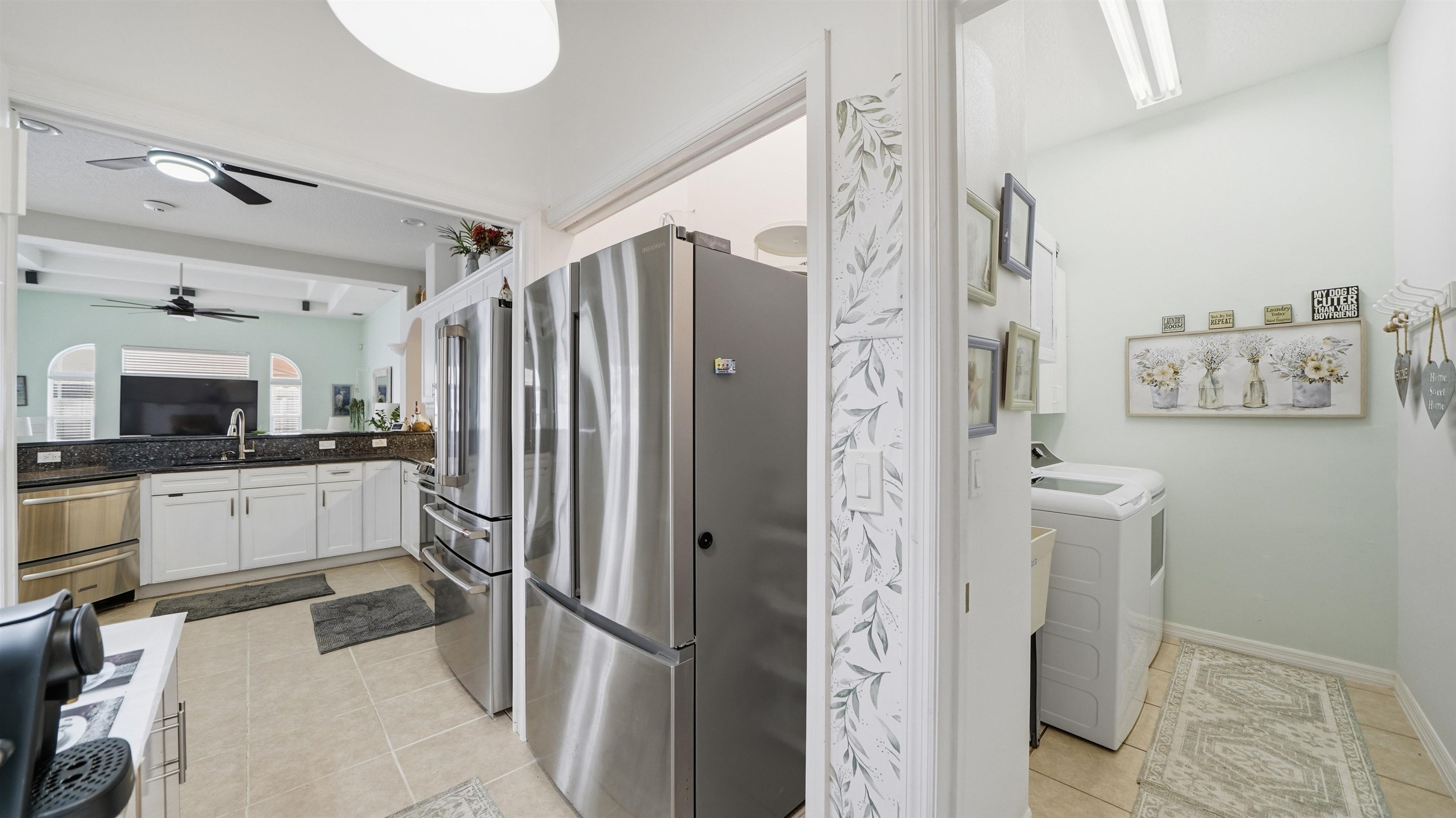22 Flanders Lane Palm Coast, FL 32137 - Photo 33 of 70 a kitchen with stainless steel appliances a refrigerator and cabinets
