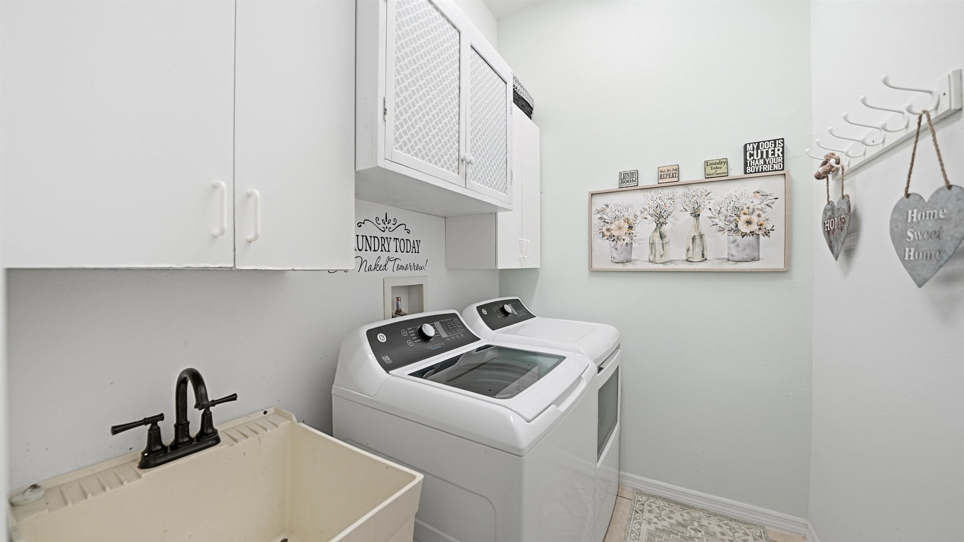 22 Flanders Lane Palm Coast, FL 32137 - Photo 34 of 70 Washroom featuring washer and dryer and cabinet space