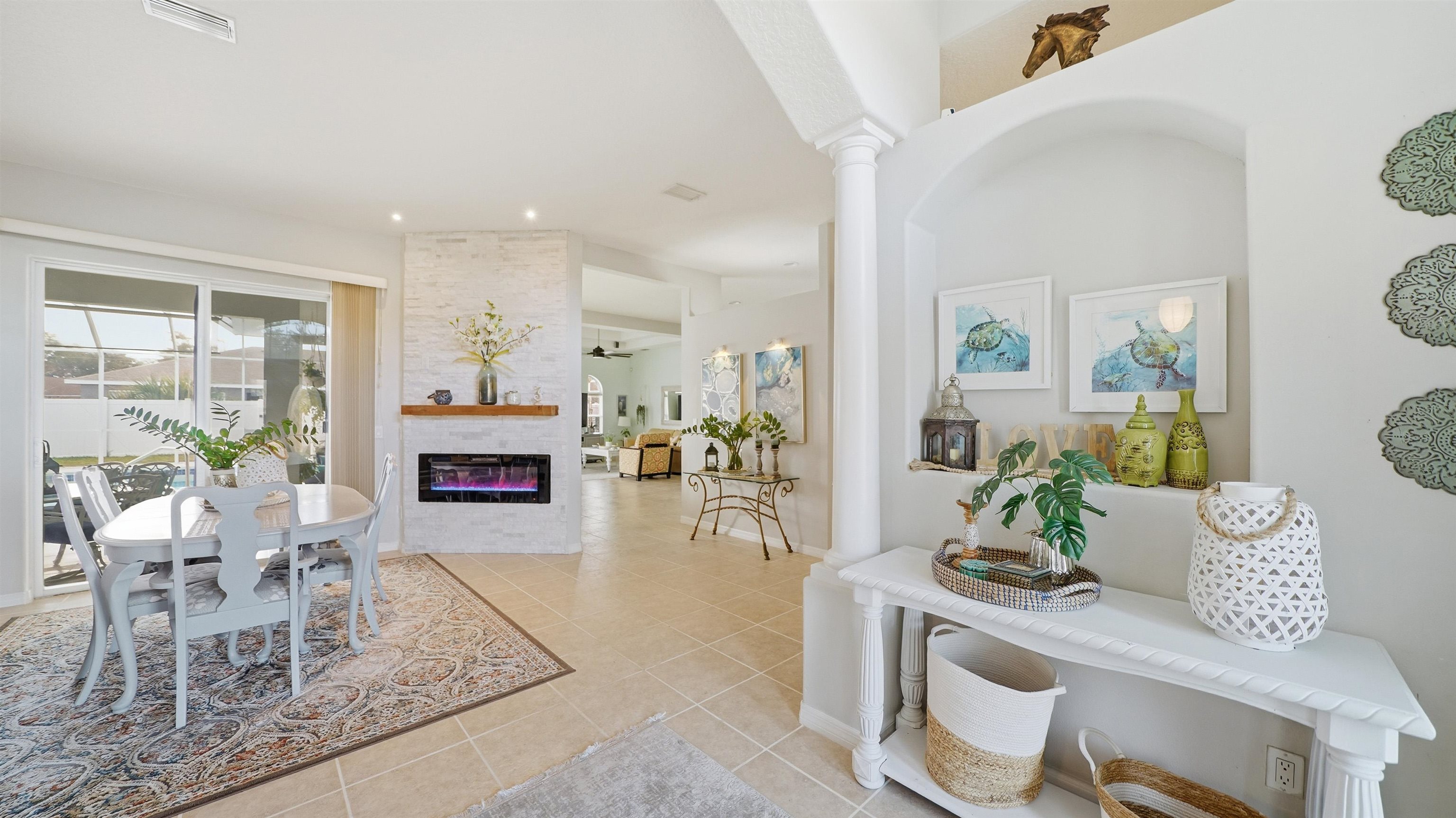 22 Flanders Lane Palm Coast, FL 32137 - Photo 4 of 70 Entrance foyer featuring a fireplace and light tile patterned floors