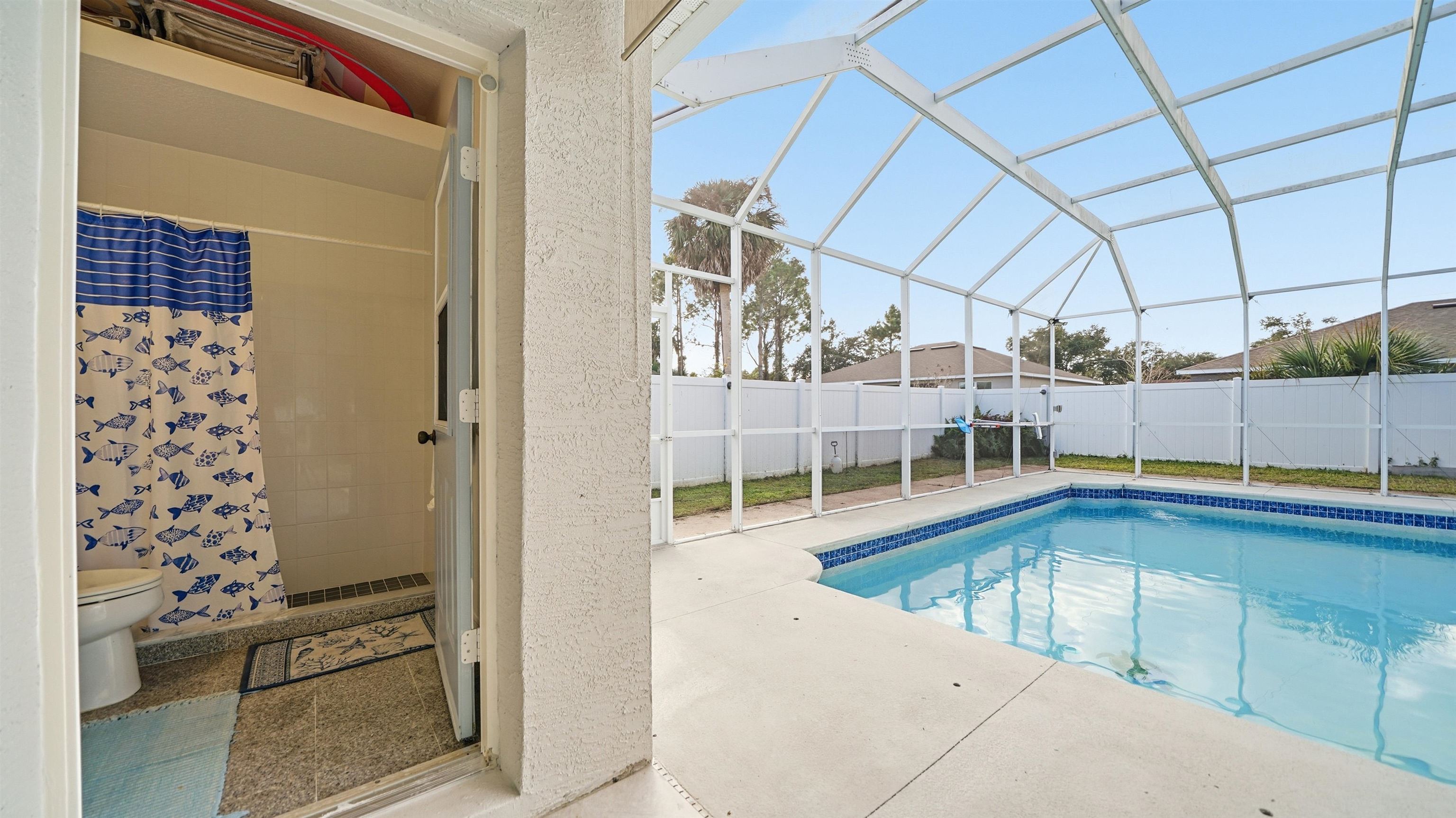 22 Flanders Lane Palm Coast, FL 32137 - Photo 45 of 70 View of pool with a sunroom, a patio area, and a lanai