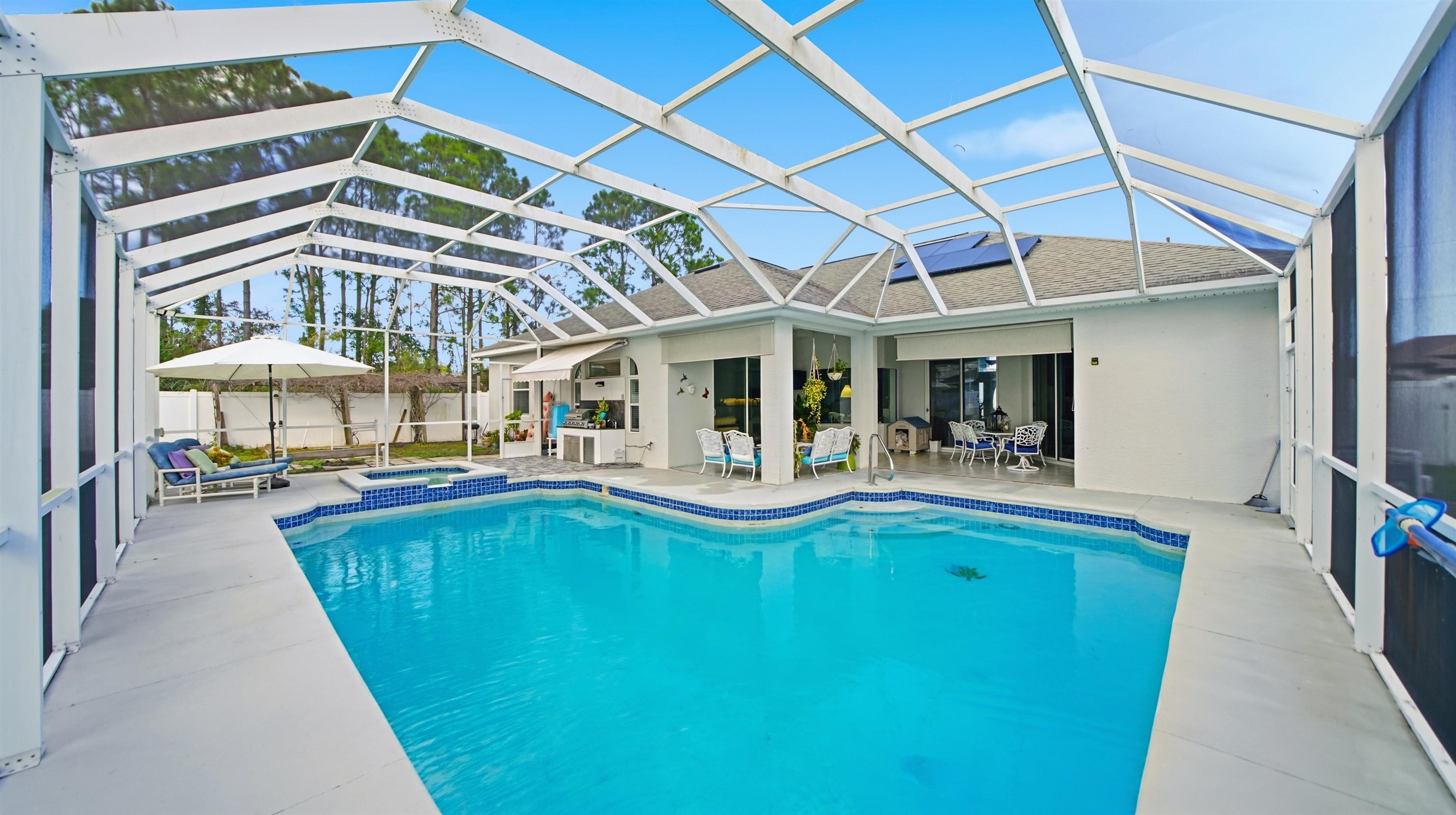 22 Flanders Lane Palm Coast, FL 32137 - Photo 52 of 70 View of pool with a sunroom, a patio area, and glass enclosure