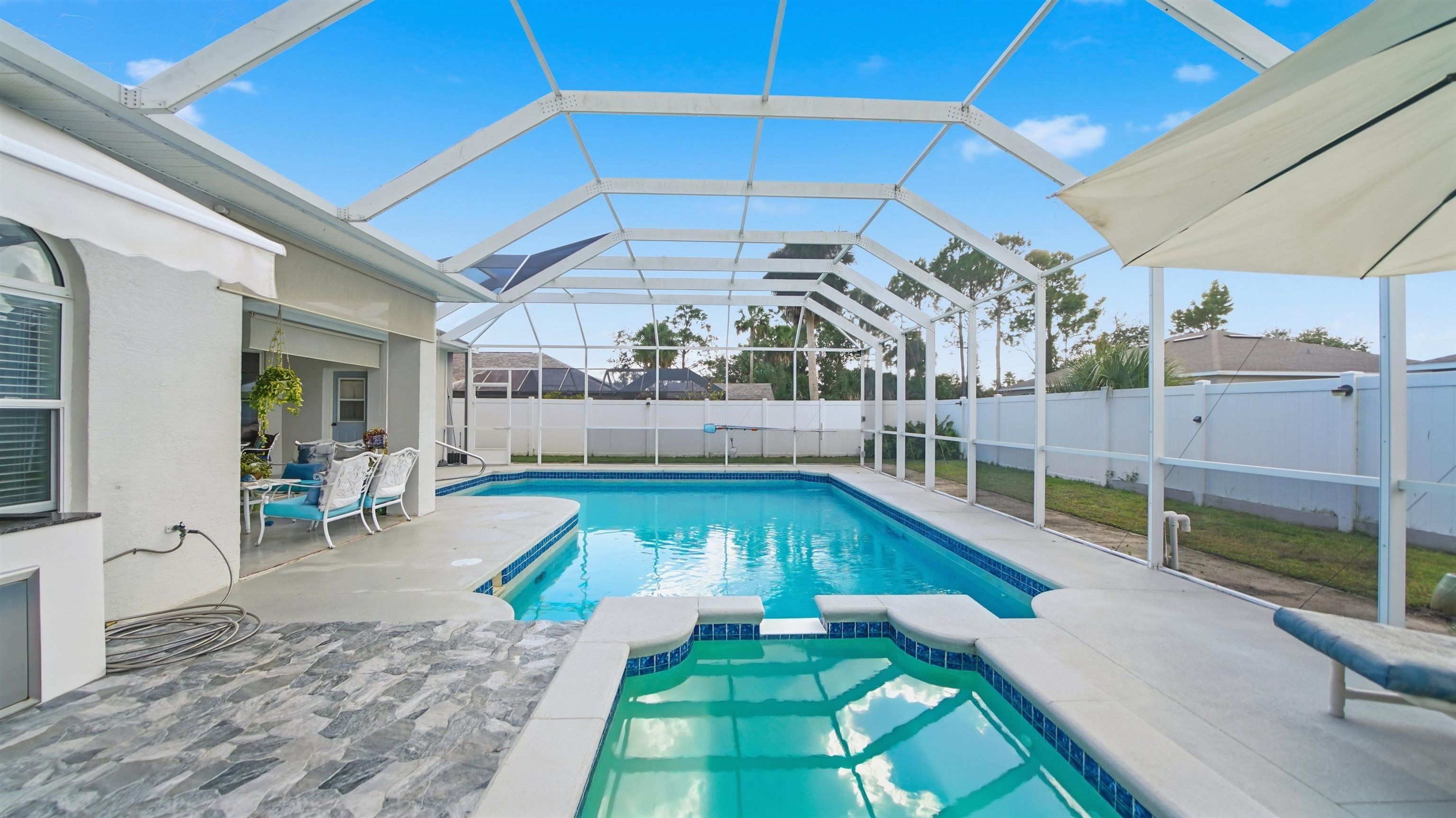 22 Flanders Lane Palm Coast, FL 32137 - Photo 54 of 70 a view of a backyard with swimming pool