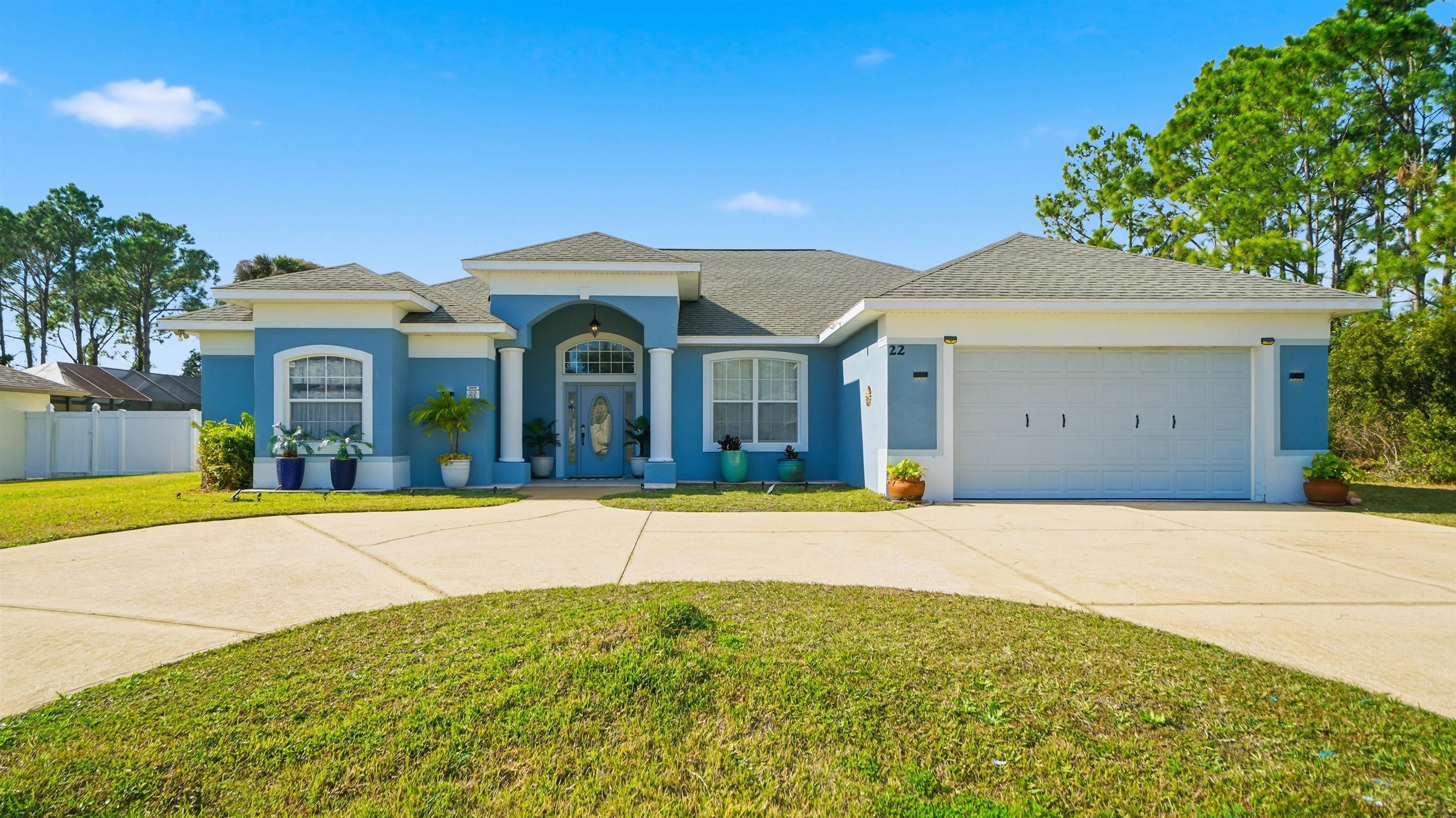 22 Flanders Lane Palm Coast, FL 32137 - Photo 61 of 70 a front view of a house with a garden