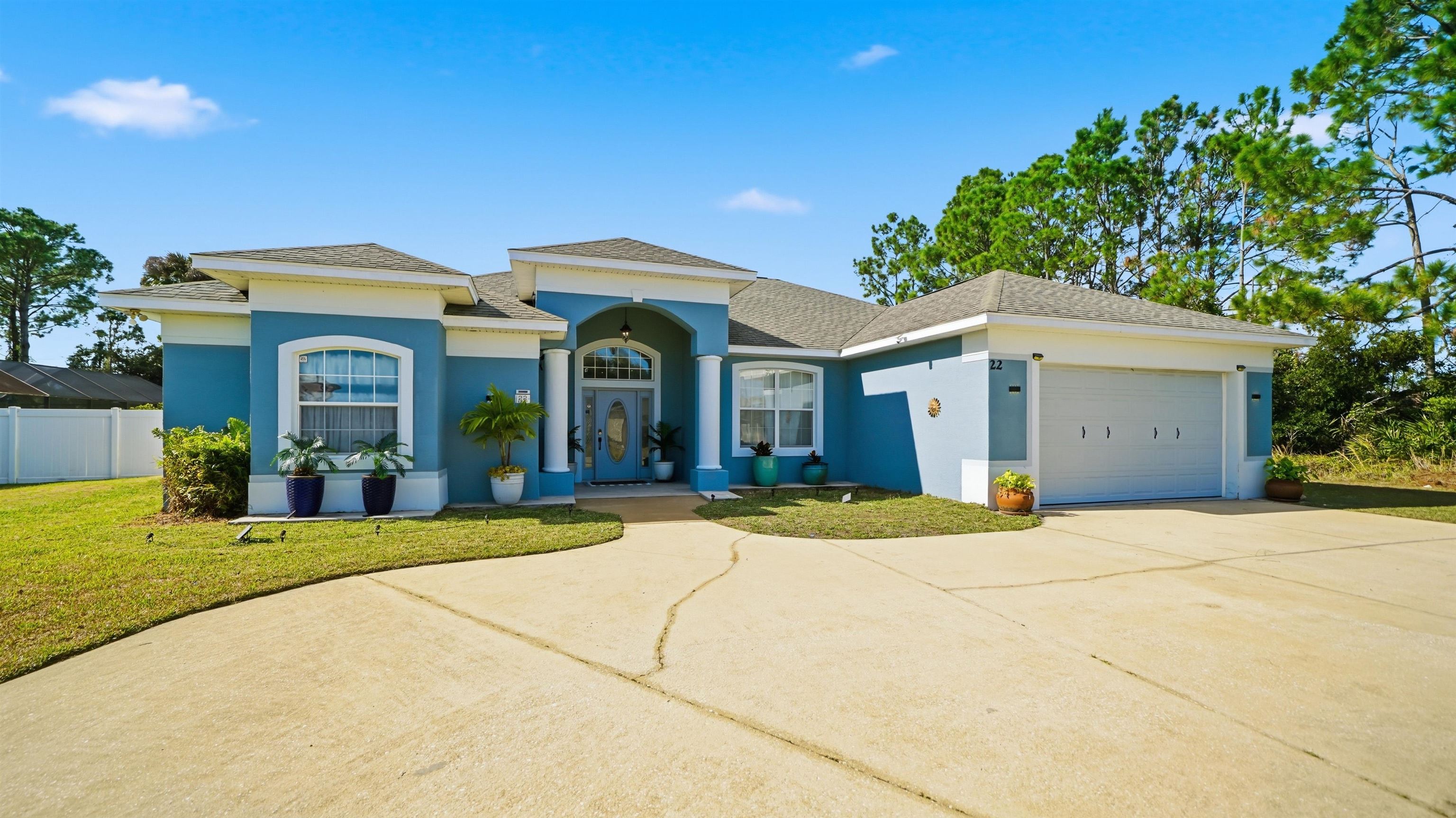 22 Flanders Lane Palm Coast, FL 32137 - Photo 62 of 70 a front view of a house with a yard