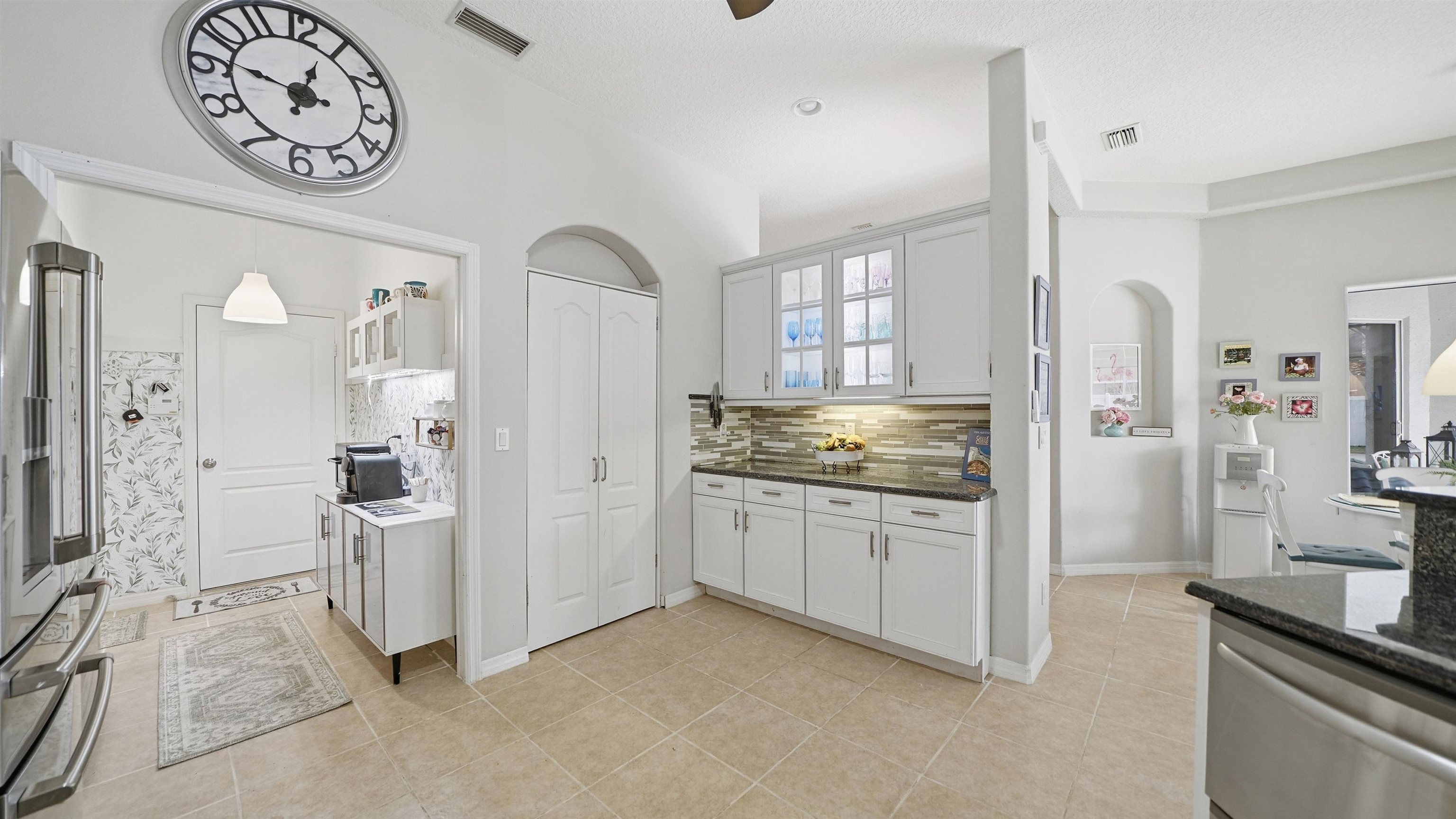 22 Flanders Lane Palm Coast, FL 32137 - Photo 9 of 70 a kitchen with stainless steel appliances granite countertop a refrigerator and a stove top oven