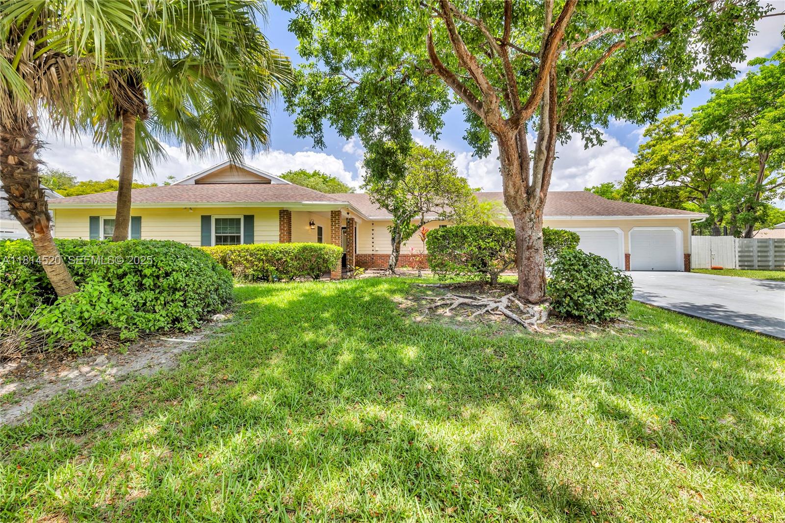 14630 Southwest 147th Court Miami, FL 33196 - Photo 1 of 17 a front view of a house with a garden