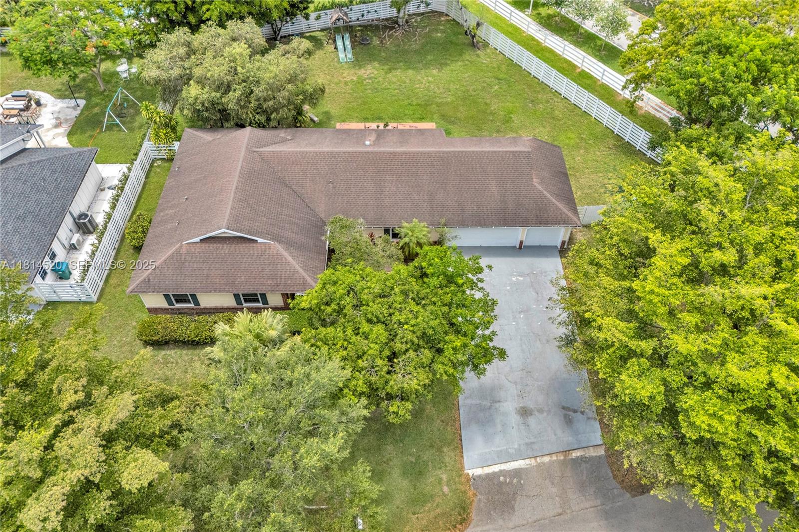 14630 Southwest 147th Court Miami, FL 33196 - Photo 12 of 17 an aerial view of a house with swimming pool and garden