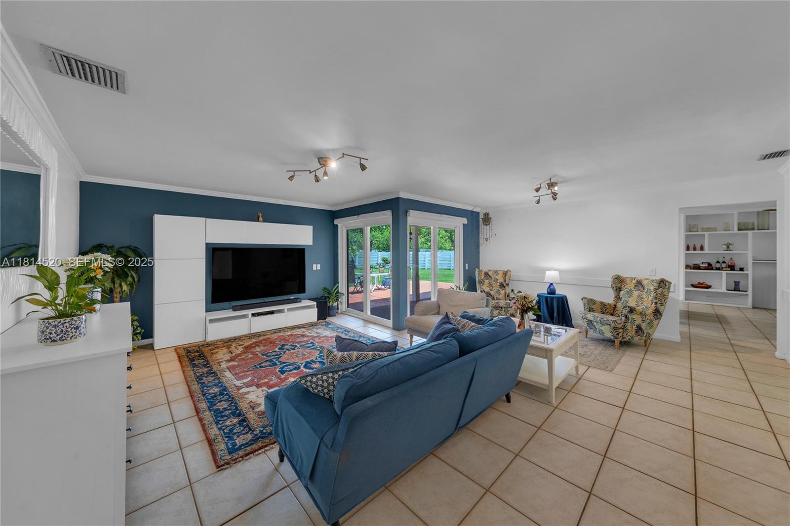 14630 Southwest 147th Court Miami, FL 33196 - Photo 4 of 17 a living room with furniture and a flat screen tv