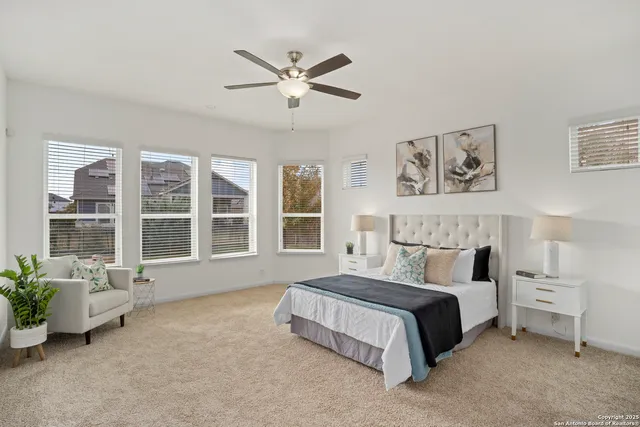 a spacious bedroom with a bed and a large window