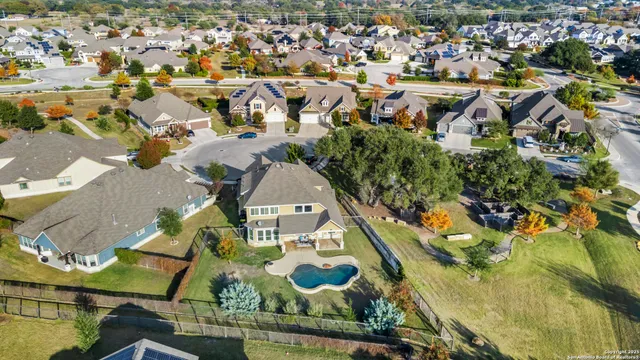 an aerial view of residential houses with outdoor space