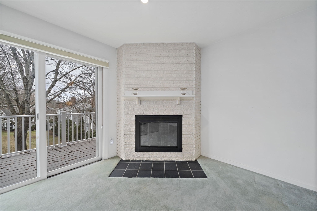 84 Walpole Street, Unit 3L Canton, MA 02021 - Photo 11 of 29 a living room with a fireplace and a rug