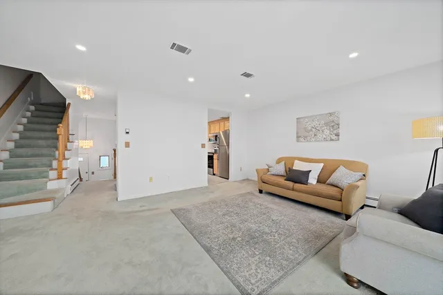 a living room with furniture and painting on the wall