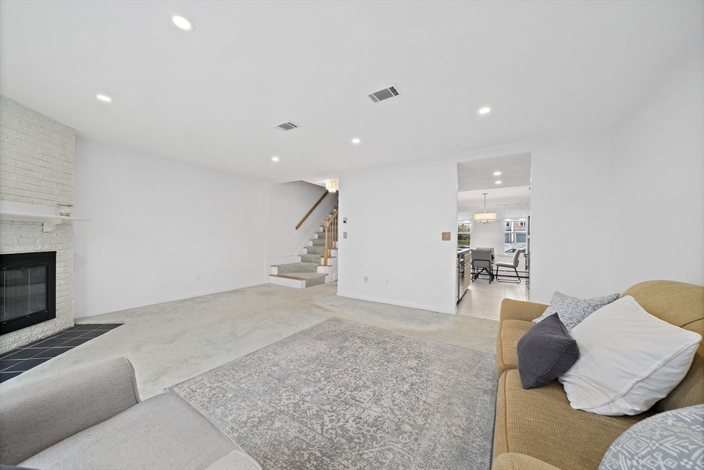 84 Walpole Street, Unit 3L Canton, MA 02021 - Photo 13 of 29 a living room with furniture and a fireplace