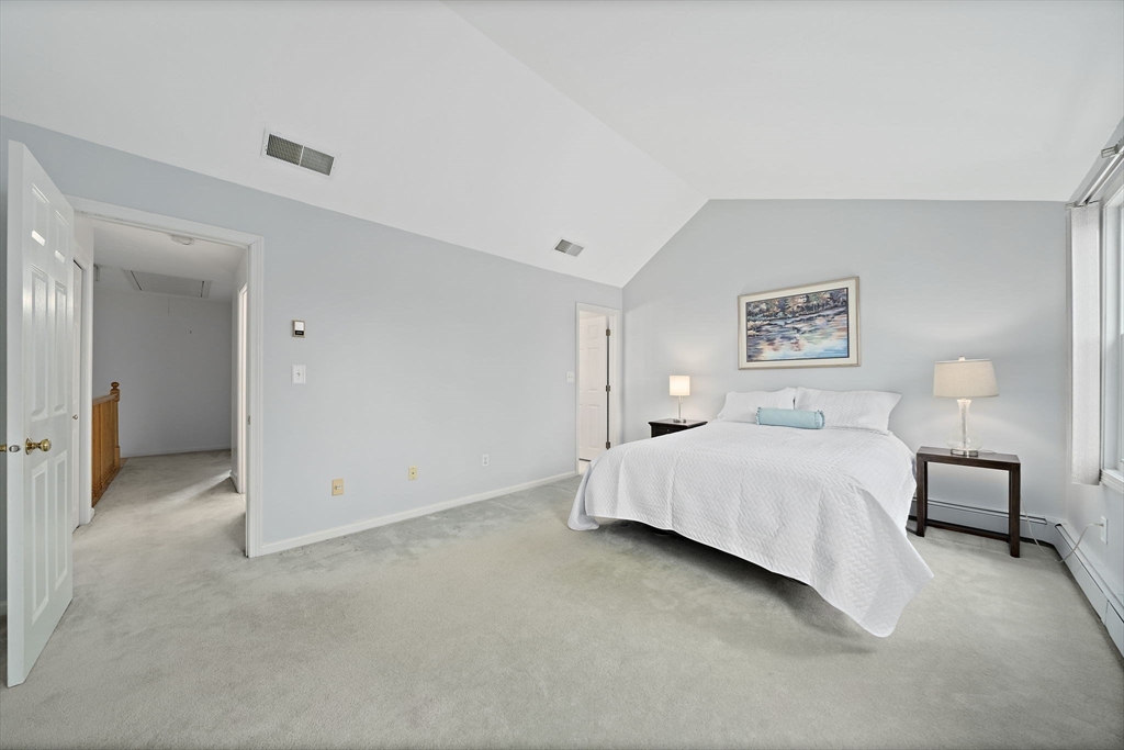84 Walpole Street, Unit 3L Canton, MA 02021 - Photo 16 of 29 a spacious bedroom with a bed and a lamp