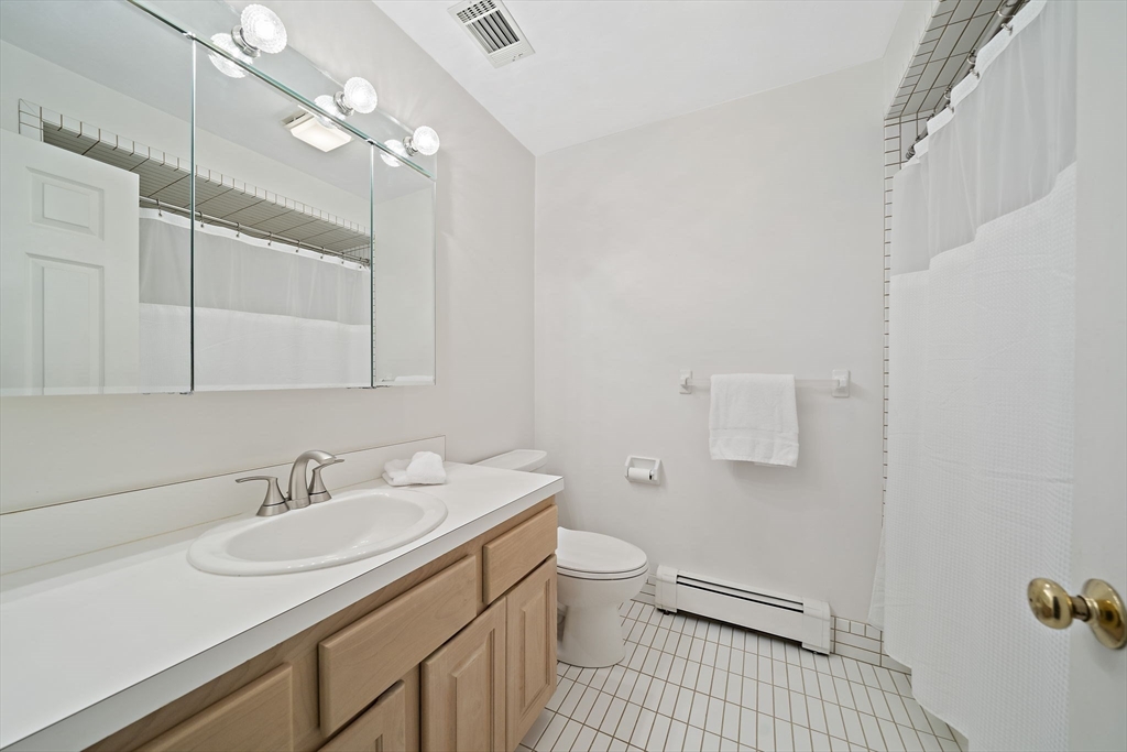 84 Walpole Street, Unit 3L Canton, MA 02021 - Photo 18 of 29 a bathroom with a sink double vanity and a toilet