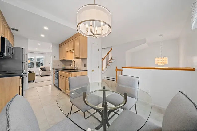 a living room with furniture a clock and a table