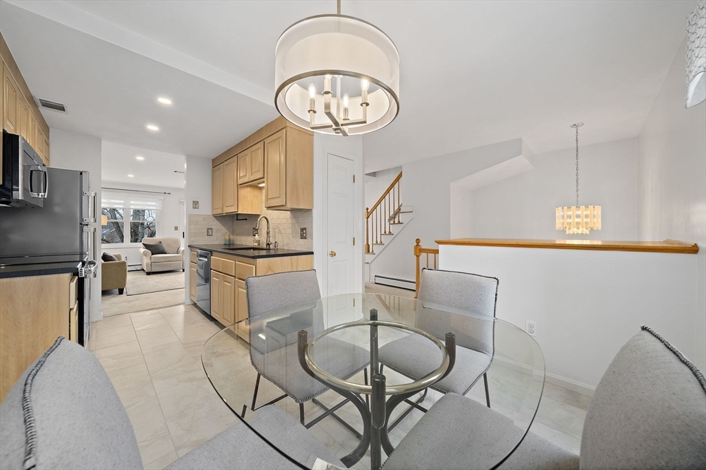 84 Walpole Street, Unit 3L Canton, MA 02021 - Photo 6 of 29 a living room with furniture a clock and a table